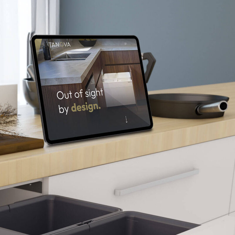 ipad on a stand in a kitchen showing Tanovas website